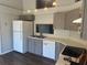 Well-lit kitchen with stainless steel appliances and gray cabinets at 7277 Pebble Pass Loop Loop, Lakeland, FL 33810