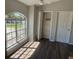 Bright living room with large arched window and lots of natural light and vinyl flooring at 7277 Pebble Pass Loop Loop, Lakeland, FL 33810