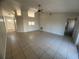 Spacious living room featuring neutral walls and tile flooring and a ceiling fan at 7277 Pebble Pass Loop Loop, Lakeland, FL 33810