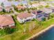 Aerial view of a landscaped home with a pool and lake view at 7515 John Hancock Dr, Winter Garden, FL 34787