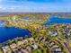 Aerial view of a waterfront community with pool, lake, and wetland views at 7515 John Hancock Dr, Winter Garden, FL 34787