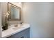 Powder bath featuring a framed mirror, white countertop, and grey vanity at 7515 John Hancock Dr, Winter Garden, FL 34787