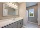 Bathroom featuring a large mirror over a gray vanity with a white countertop at 7515 John Hancock Dr, Winter Garden, FL 34787