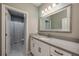 Bathroom featuring a large mirror over a vanity with a white countertop at 7515 John Hancock Dr, Winter Garden, FL 34787