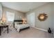 Cozy bedroom with neutral walls, desk, and a mirror wall decoration at 7515 John Hancock Dr, Winter Garden, FL 34787