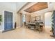 The dining room is well lit with modern furnishings and a rustic wood planked tray ceiling at 7515 John Hancock Dr, Winter Garden, FL 34787