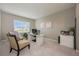 Bright home office with a modern desk, cozy seating, and natural light from a window at 7515 John Hancock Dr, Winter Garden, FL 34787