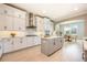 The bright white kitchen features stainless appliances and an island with storage at 7515 John Hancock Dr, Winter Garden, FL 34787