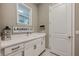 Laundry room with white cabinets, sink, window, decor, and tile floors at 7515 John Hancock Dr, Winter Garden, FL 34787