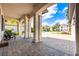 Covered front porch with columns and brick flooring at 7515 John Hancock Dr, Winter Garden, FL 34787