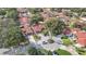 Neighborhood aerial view of homes with red roofs on circular, well-maintained lawns and lush trees at 8218 Borgia Ct, Orlando, FL 32836