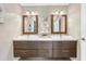 Elegant bathroom featuring a double sink vanity, framed mirrors, modern lighting, and sleek fixtures at 8218 Borgia Ct, Orlando, FL 32836