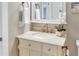 Bathroom featuring a marble vanity, neutral paint, framed mirror and modern lighting at 8218 Borgia Ct, Orlando, FL 32836