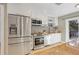 Modern kitchen featuring stainless steel appliances, granite counters, and white cabinets at 8218 Borgia Ct, Orlando, FL 32836