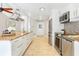 Stylish kitchen featuring stainless steel appliances, granite countertops, and white cabinetry at 8218 Borgia Ct, Orlando, FL 32836