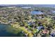 Expansive aerial of a waterfront homes and neighborhood with private docks and scenic lake views at 85 Interlaken Rd, Orlando, FL 32804