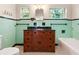 Bright bathroom featuring vintage tile and a custom wood vanity with black countertop at 85 Interlaken Rd, Orlando, FL 32804