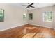 Sunny bedroom featuring hardwood floors and bright windows with classic blinds at 85 Interlaken Rd, Orlando, FL 32804