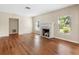 Cozy living room with hardwood floors, a white fireplace, and lots of natural light at 85 Interlaken Rd, Orlando, FL 32804