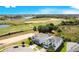 Aerial view of a home with a screened-in pool, situated near a scenic golf course and lush landscape at 8800 Interlocking Ct, Champions Gate, FL 33896