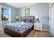 Comfortable bedroom with a large window, stylish headboard, and matching nightstands at 8800 Interlocking Ct, Champions Gate, FL 33896