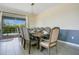 Elegant dining room with a large table, comfortable seating, and sliding glass doors leading to an outdoor area at 8800 Interlocking Ct, Champions Gate, FL 33896