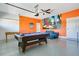 Spacious game room with a pool table, foosball table, and vibrant wall art, perfect for entertainment at 8800 Interlocking Ct, Champions Gate, FL 33896