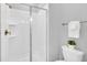 Bright bathroom features a glass shower door, crisp white tile, and fixtures at 9017 Dogleg Dr, Davenport, FL 33896