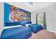 The bedroom has two twin beds and a colorful Toy Story themed wall at 9017 Dogleg Dr, Davenport, FL 33896