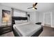 Bedroom boasts a large upholstered headboard, stylish art, and ceiling fan at 9017 Dogleg Dr, Davenport, FL 33896