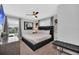 Bedroom featuring large windows, curtains, dark headboard, dresser, and ceiling fan at 9017 Dogleg Dr, Davenport, FL 33896