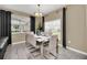 Bright dining area with a modern chandelier and seating for eight, with a large window at 9017 Dogleg Dr, Davenport, FL 33896