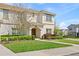 Charming two-story home with a well-maintained lawn, mature landscaping, and welcoming facade at 9017 Dogleg Dr, Davenport, FL 33896