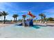 Community splash pad with slides, a tipping bucket, and colorful play features at 9017 Dogleg Dr, Davenport, FL 33896