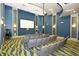 Community theater room features tiered seating, a large screen, and a modern projector at 9017 Dogleg Dr, Davenport, FL 33896