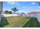 Spacious fenced backyard with lush green grass and a mature palm tree at 944 Glen Abbey Cir, Winter Springs, FL 32708