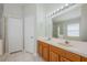 Well-lit bathroom with a double sink vanity, large mirror, and walk-in shower, offering comfort and convenience at 944 Glen Abbey Cir, Winter Springs, FL 32708