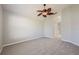 Spacious bedroom with neutral carpet and fan, plus convenient access to bathroom at 944 Glen Abbey Cir, Winter Springs, FL 32708