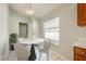 Cozy breakfast nook with a modern round table, stylish chairs, and natural light from the window at 944 Glen Abbey Cir, Winter Springs, FL 32708