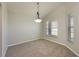 Dining room featuring neutral colored walls, carpet, modern lighting fixture, and natural light at 944 Glen Abbey Cir, Winter Springs, FL 32708