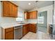 Functional kitchen featuring stainless steel dishwasher, ample cabinetry, and easy access to the adjacent living space at 944 Glen Abbey Cir, Winter Springs, FL 32708