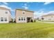 Enjoy the backyard of this home, ideal for outdoor activities with a covered patio and lush green grass at 1100 Downswing Pl, Davenport, FL 33896