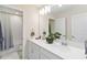 Bright bathroom featuring a double vanity with modern fixtures and a shower-tub combination with elegant tile work at 1100 Downswing Pl, Davenport, FL 33896