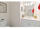 Half bath features a pedestal sink, white cabinetry, and neutral decor at 1100 Downswing Pl, Davenport, FL 33896