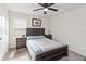 Inviting bedroom features a wood-framed bed with a ceiling fan and neutral tones creating a relaxing ambiance at 1100 Downswing Pl, Davenport, FL 33896