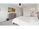Cozy bedroom with a large flatscreen television, carpet, and a glimpse of the Primary bath at 1100 Downswing Pl, Davenport, FL 33896