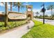 ChampionsGate community entrance with stone signage, landscaping, and a charming entry structure on a sunny day at 1100 Downswing Pl, Davenport, FL 33896