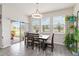 Bright dining room featuring lots of natural light with sliding glass doors and modern light fixture at 1100 Downswing Pl, Davenport, FL 33896