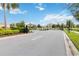 Community gated entrance featuring black metal gates, mature landscaping, and secure access for residents and guests at 1100 Downswing Pl, Davenport, FL 33896