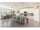 Modern kitchen with white cabinets, gray countertops, an island with seating, and stainless steel appliances at 1100 Downswing Pl, Davenport, FL 33896